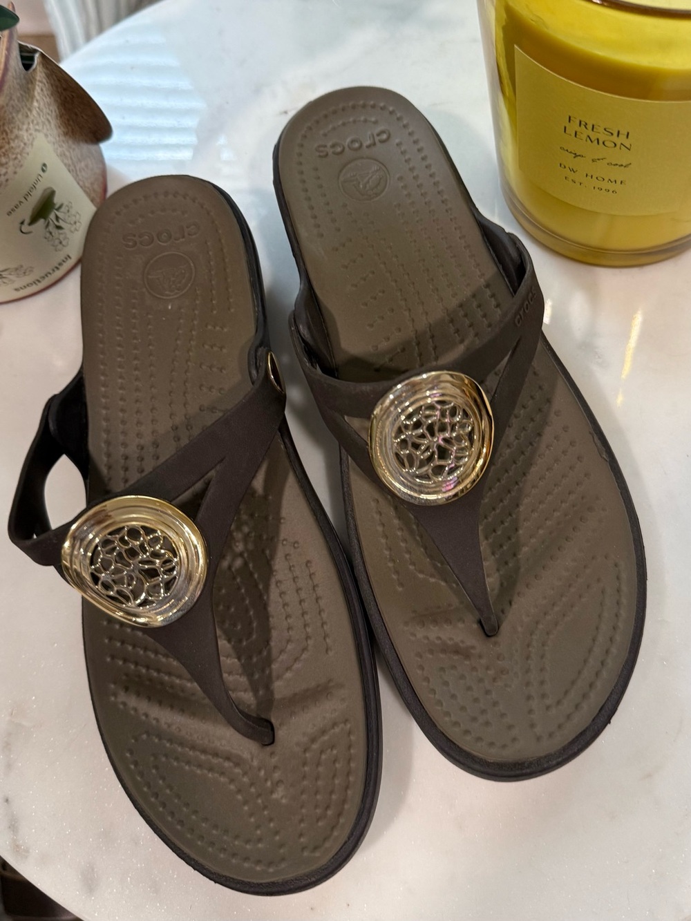 CROCS Dark Brown Thong Sandals with Gold Decorative Medallion
